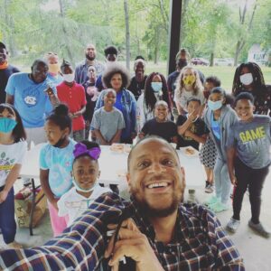 Project BOLT nonprofit co-founder Gemini Boyd takes a selfie with a group of kids outside
