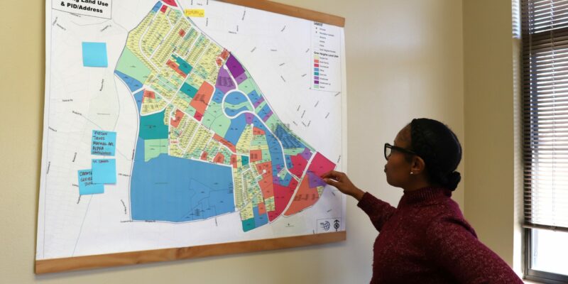 Tiffany Capers points at a map of Grier Heights