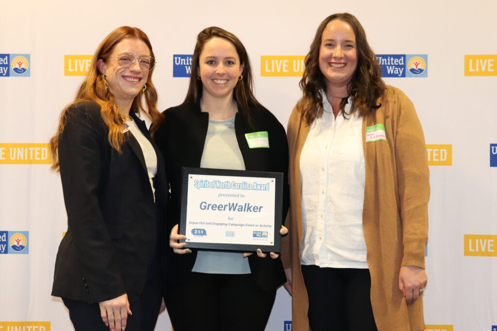 United Way Corporate Relations Manager Kim Savage stands with recipients from GreerWalker.