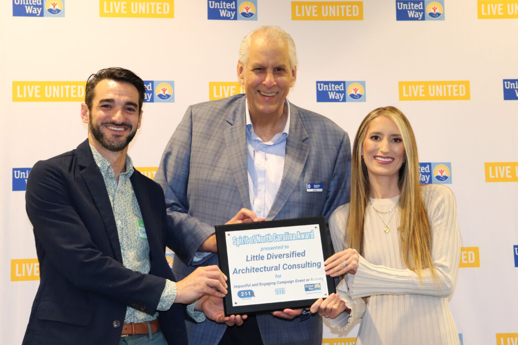 United Way Senior Corporate Relationship Manager David Dulin stands with recipients from Little Diversified Architectural Consulting.