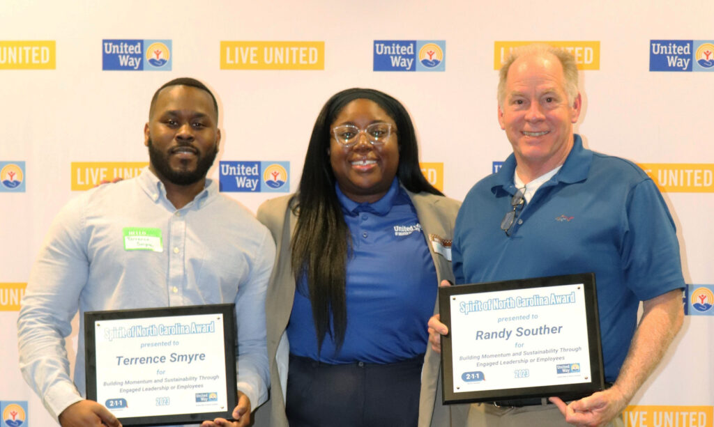 United Way Regional Director serving Cabarrus County Raijene Walker stands with recipients Terrence Smyre and Randy Souther.